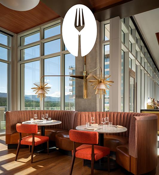 Seating at Pamela's with the logo above a chandelier