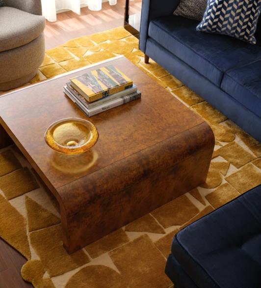 A brown wooden table with books and a bowl on it