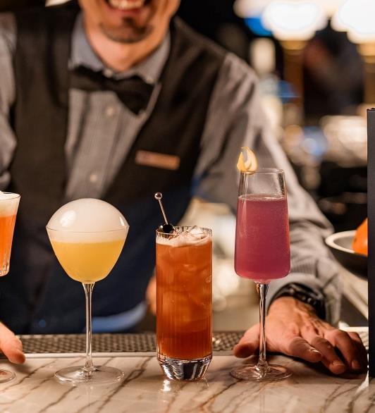 A bartender making colorful cocktails