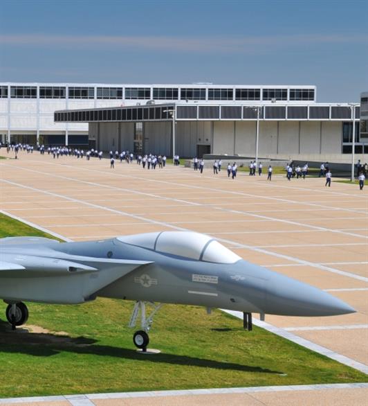 A jet followed by cadets walking behind it