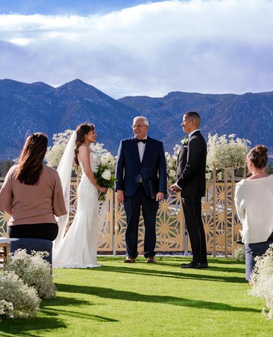 A bride and groom getting married on the outdoor terrace