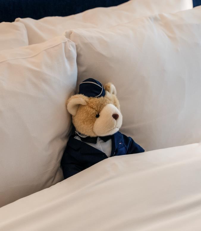 A stuffed bear in a bed
