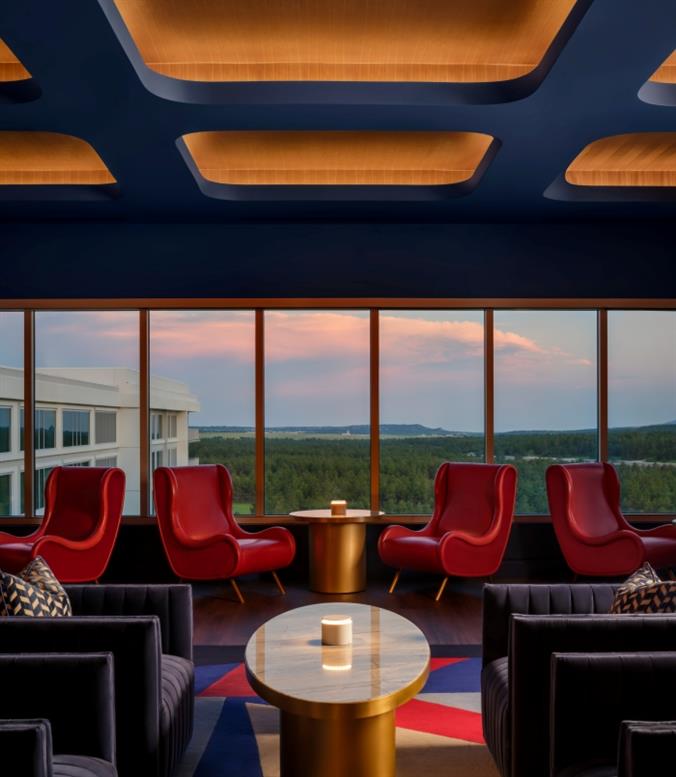 A view of a lounge and a sunset in the background