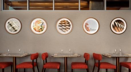 Tables back to back with cool circular picture above them