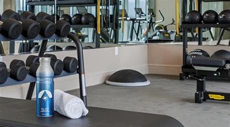 A Hotel Polaris water bottle next to workout equipment