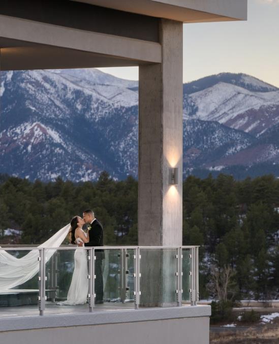A couple kissing and mountain range behind them