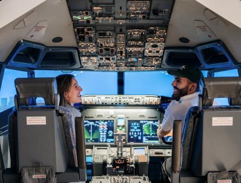 Two people in a flight simulator