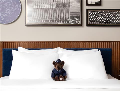A stuffed bear on a bed
