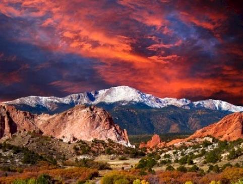 A photo of a mountain range with a beautiful sunset behind it