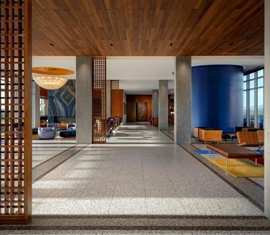 Spacious Hotel Polaris lobby featuring wood lattice details, modern lounge seating, and floor-to-ceiling windows.