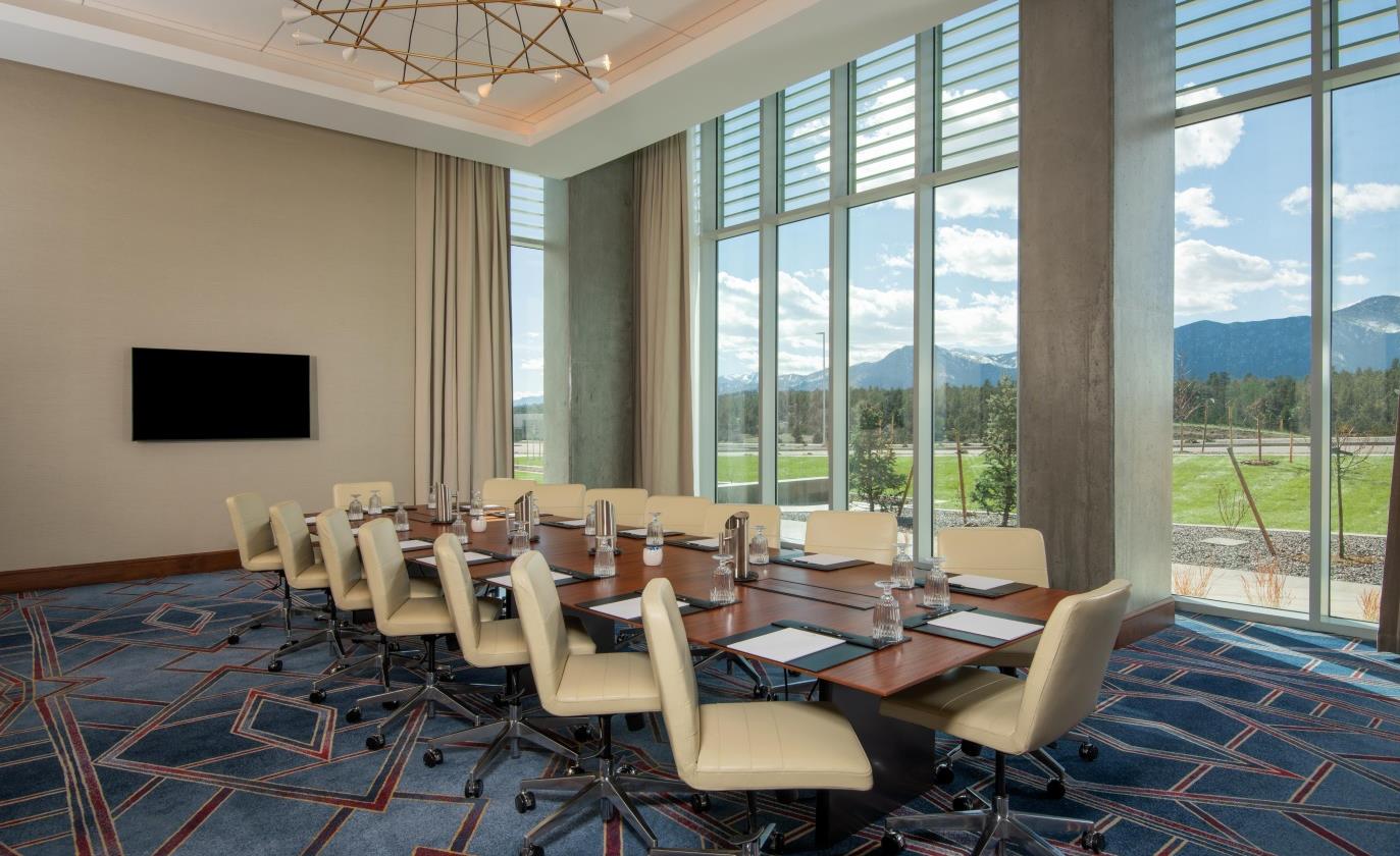 A meeting room with a screen on the back wall