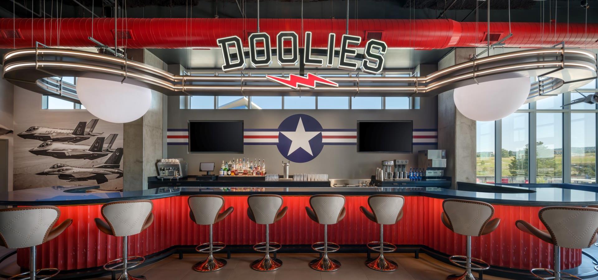 a bar with a red and black color scheme and aviator-themed decor