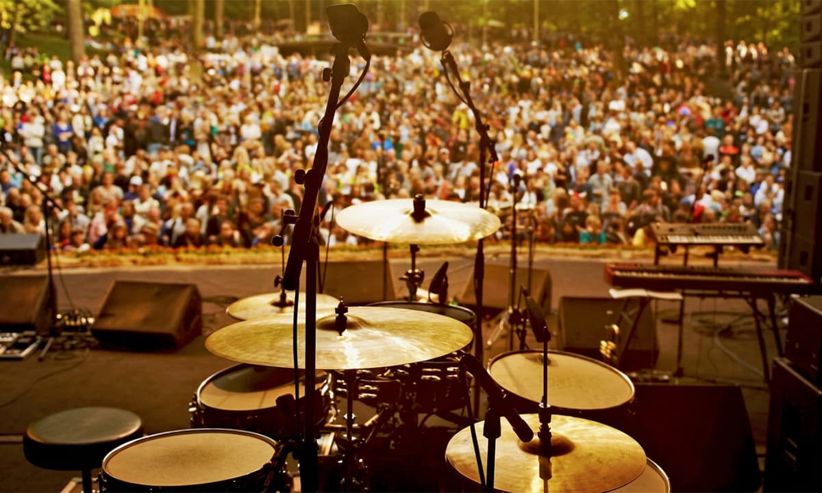 drums on stage with crowd in background